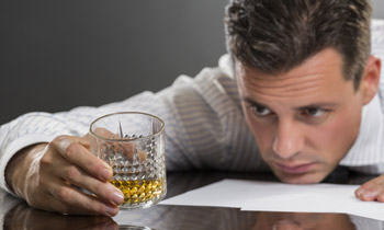 man looking at drink 350